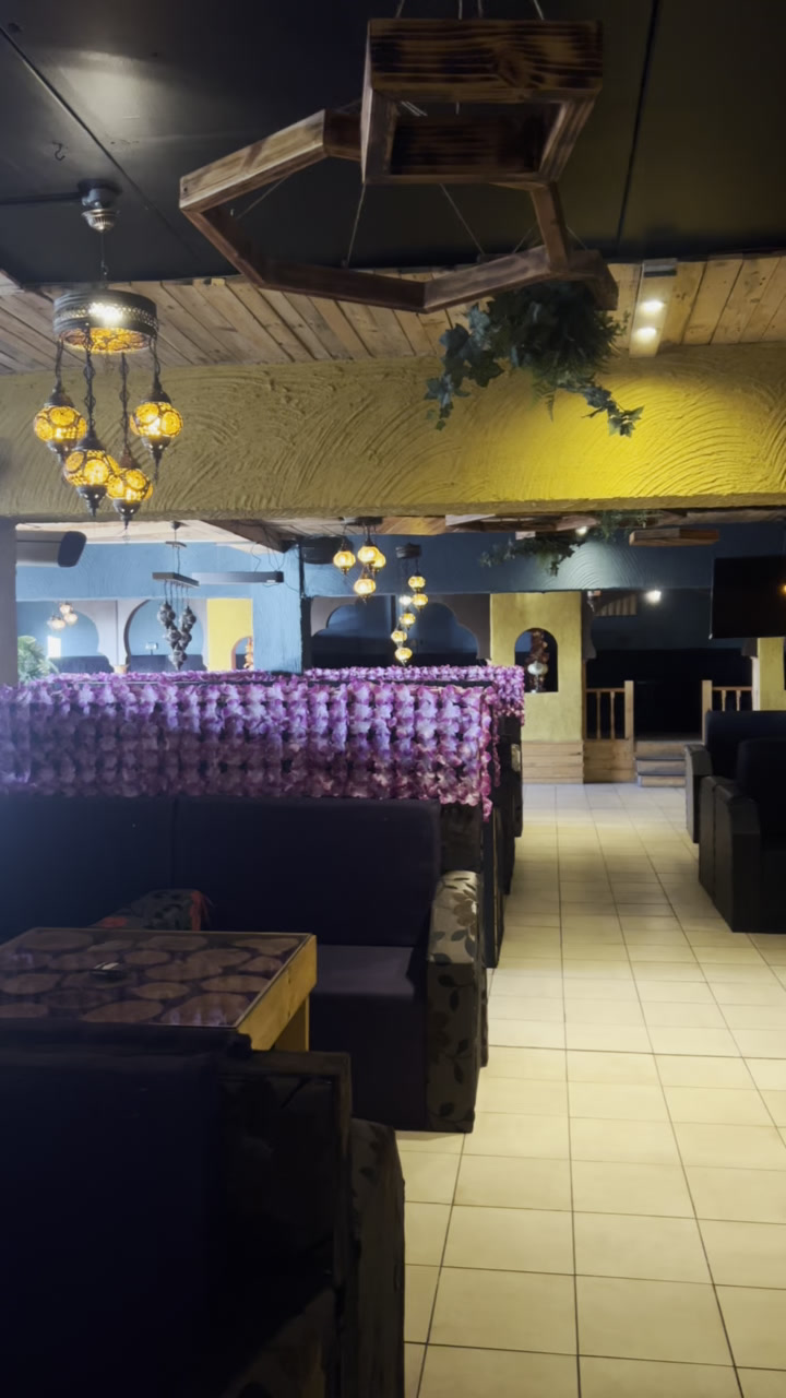 Inside Babylon Lounge - booth seating, flower wall and lanterns